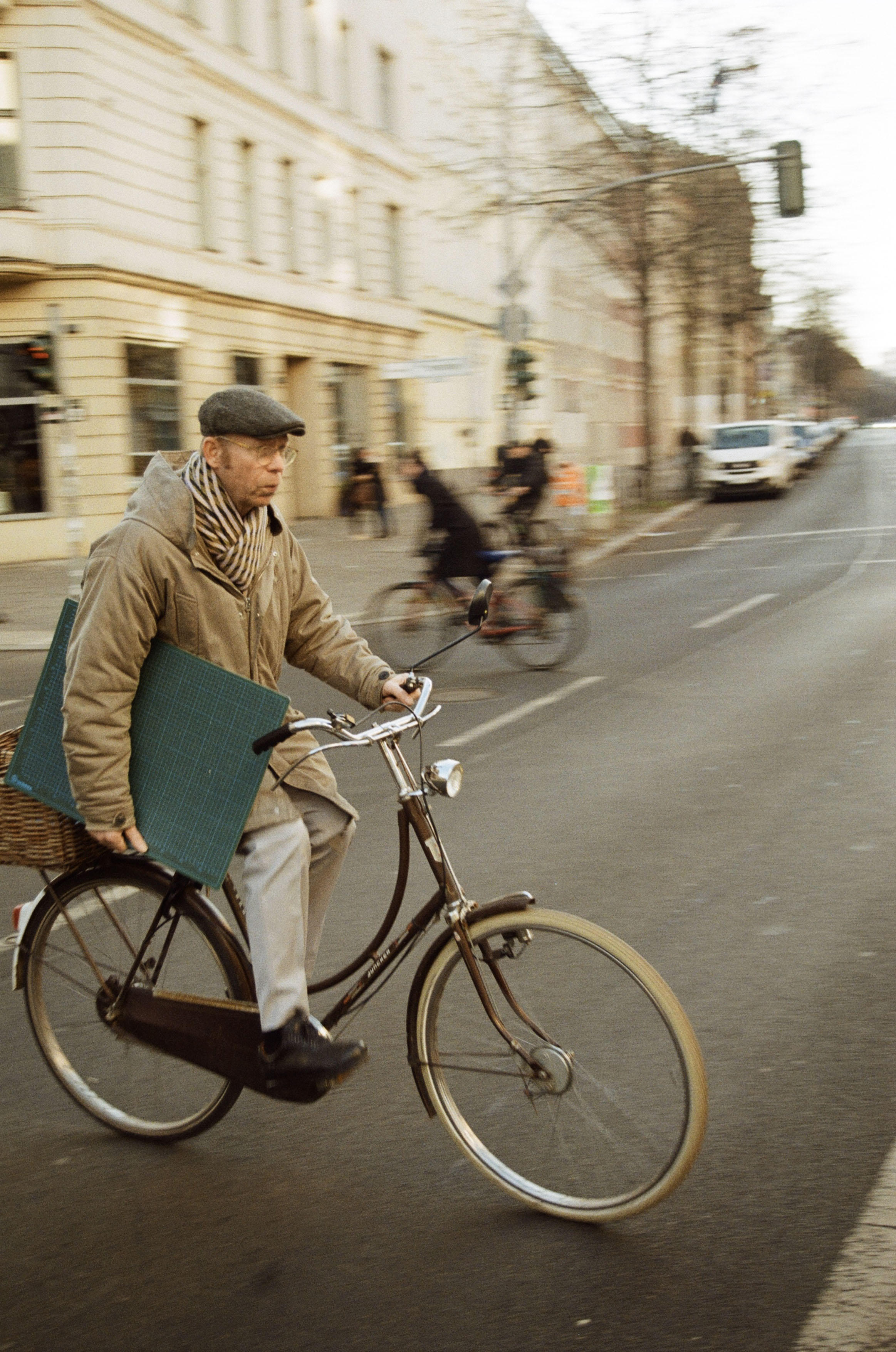 photo of a man cycling holding a cutting mat
