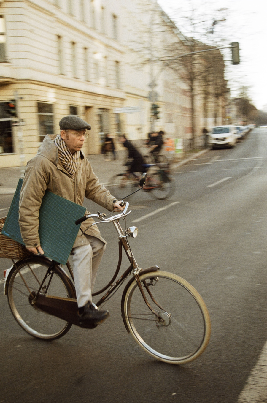 photo of a man cycling holding a cutting mat